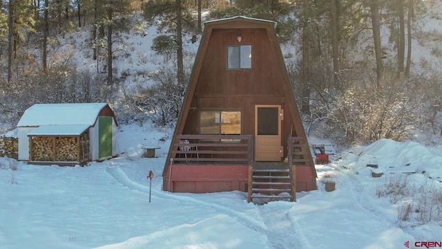 view of front of home with a shed