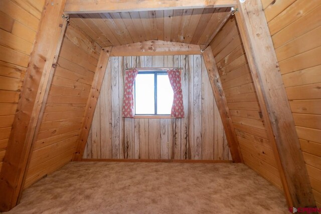 1015 E Stollsteimer Rd, Pagosa Springs, CO 81147 - additional living space with lofted ceiling, wood walls, carpet, and wood ceiling