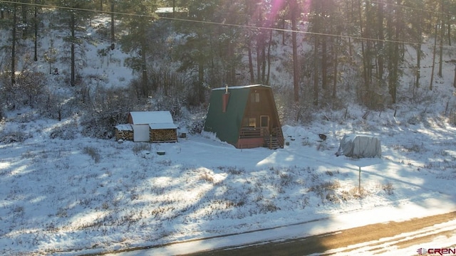1015 E Stollsteimer Rd, Pagosa Springs, CO 81147 - yard layered in snow featuring a view of trees
