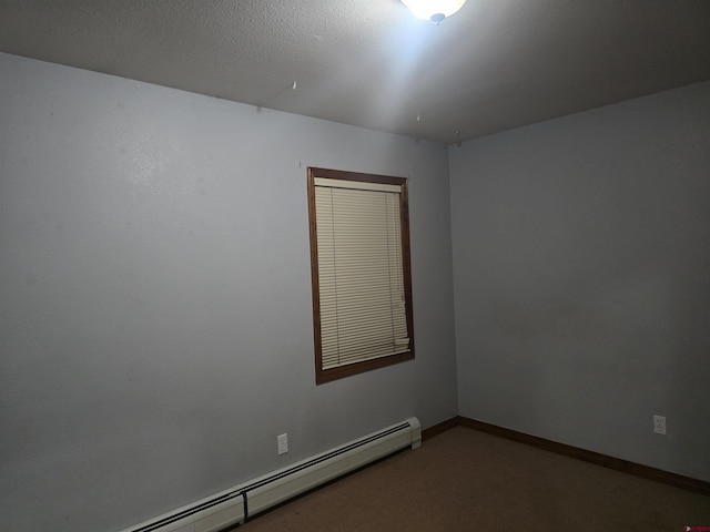 empty room featuring a baseboard radiator, carpet flooring, and a textured ceiling