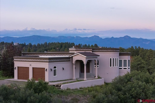 view of front facade with a mountain view and a garage