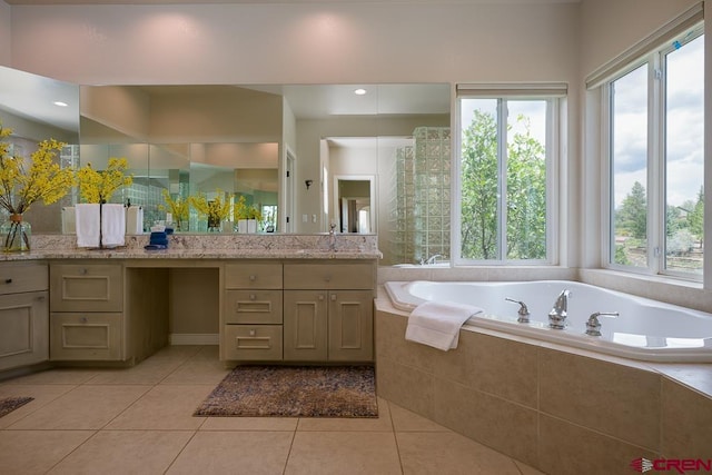 bathroom featuring a healthy amount of sunlight, tile patterned flooring, and vanity