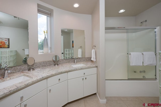 bathroom featuring vanity, shower / bath combination with glass door, and tile patterned flooring