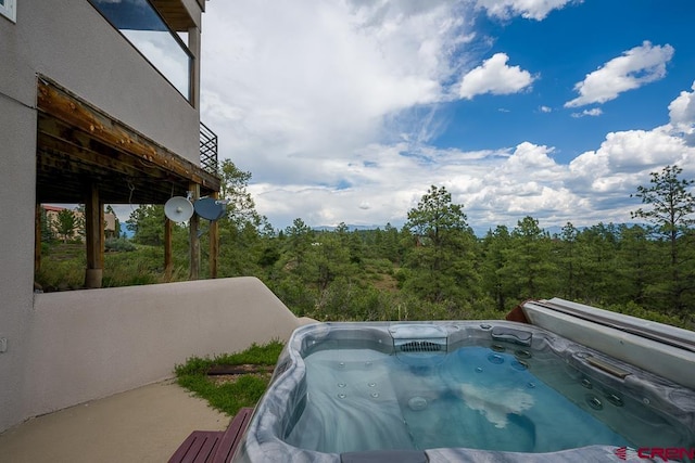 view of pool with a hot tub