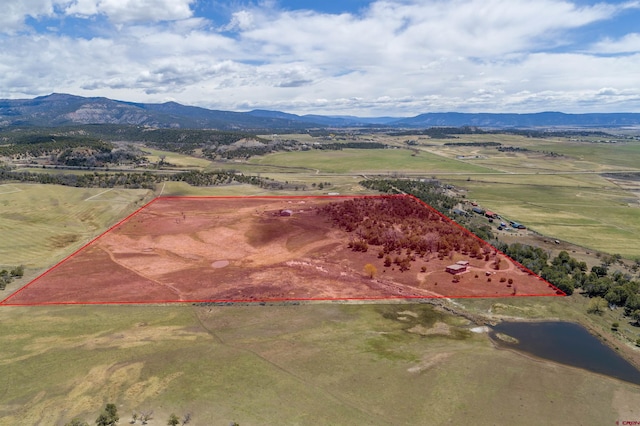 birds eye view of property featuring a mountain view and a rural view