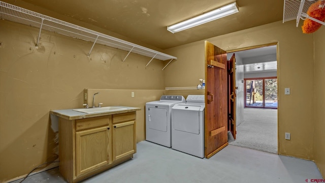 laundry room featuring sink and washer and dryer