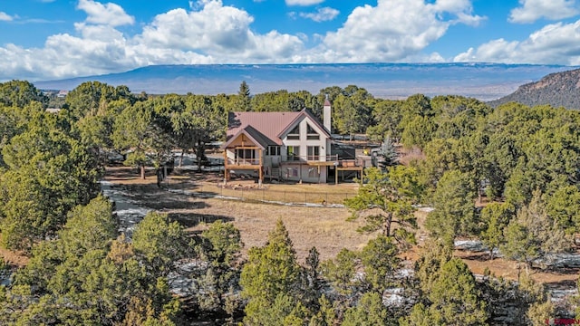 bird's eye view featuring a mountain view and a view of trees