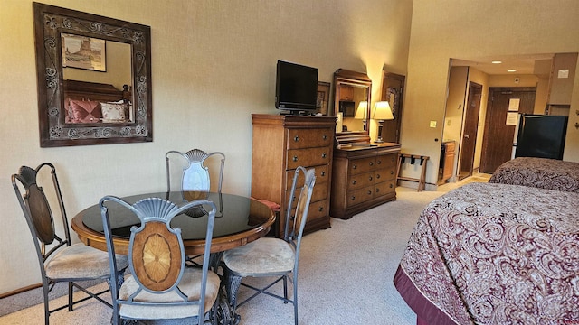 carpeted bedroom with refrigerator