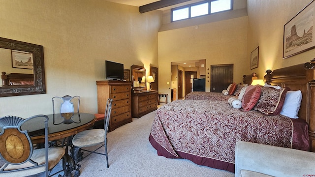 bedroom featuring light colored carpet, beam ceiling, and a towering ceiling