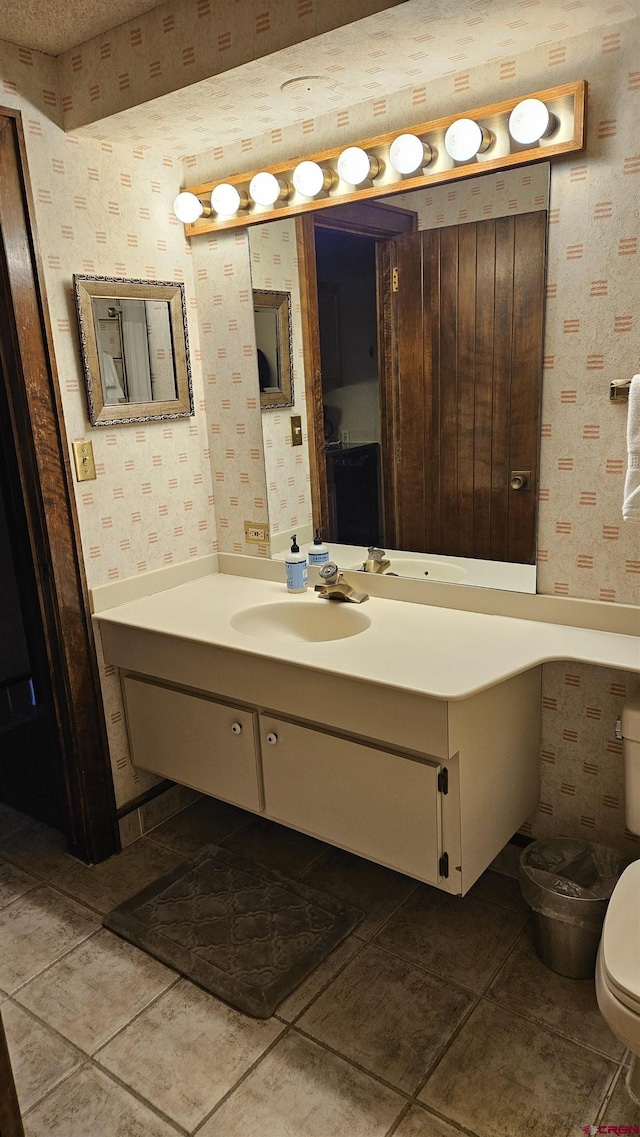 bathroom with tile patterned floors, vanity, and toilet