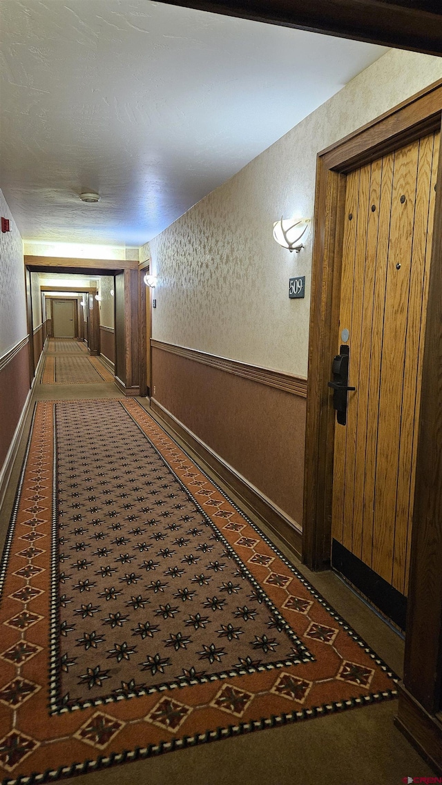 corridor featuring wooden walls