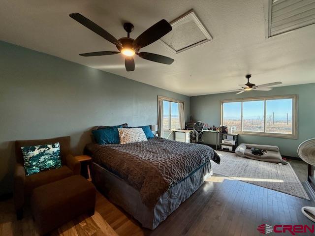 bedroom featuring hardwood / wood-style floors and ceiling fan