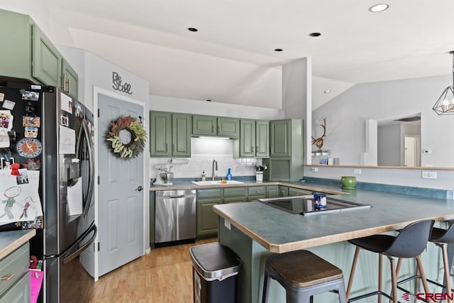 kitchen featuring green cabinetry, appliances with stainless steel finishes, and kitchen peninsula