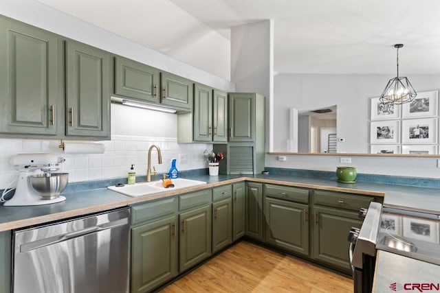 kitchen featuring green cabinets, appliances with stainless steel finishes, sink, and lofted ceiling