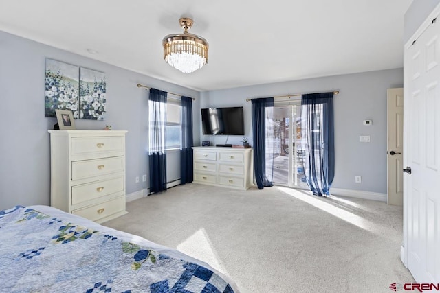 bedroom featuring light colored carpet, a baseboard heating unit, and a notable chandelier