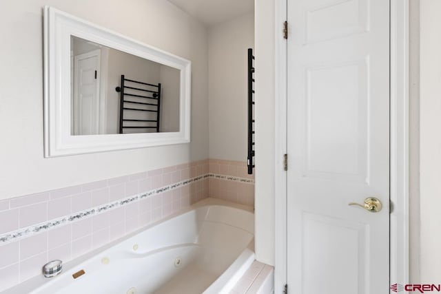 bathroom with a tub and radiator