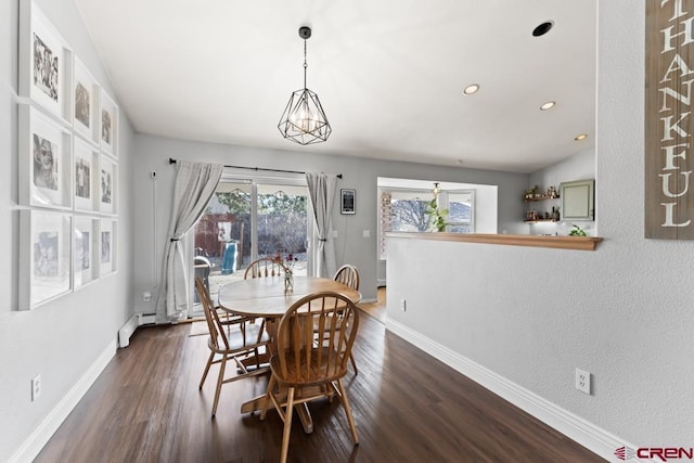 dining room with dark hardwood / wood-style floors and baseboard heating