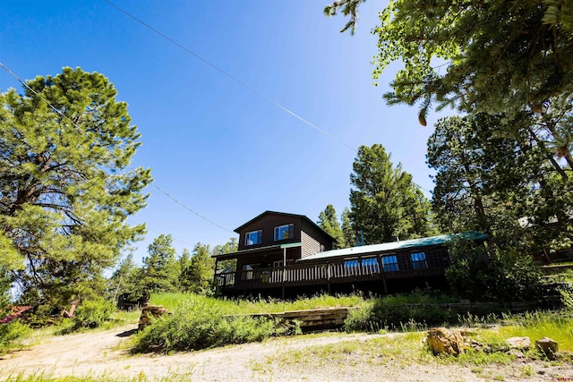 rear view of property with a wooden deck