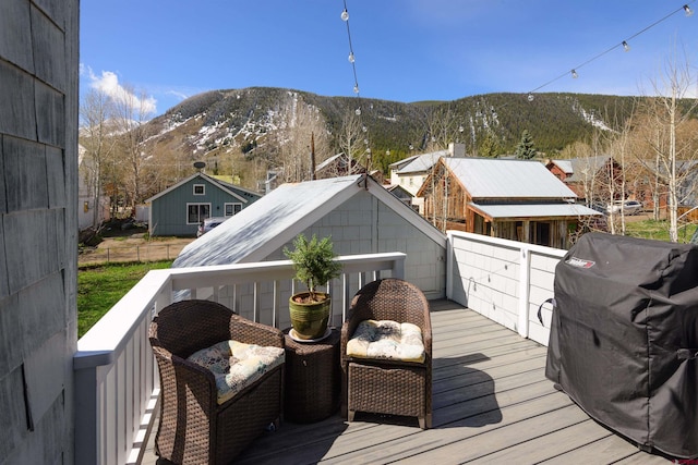 wooden terrace featuring a mountain view and area for grilling