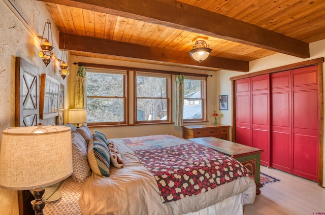 bedroom featuring wood ceiling, a closet, multiple windows, and beamed ceiling