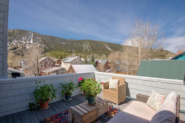 balcony featuring a mountain view and an outdoor living space