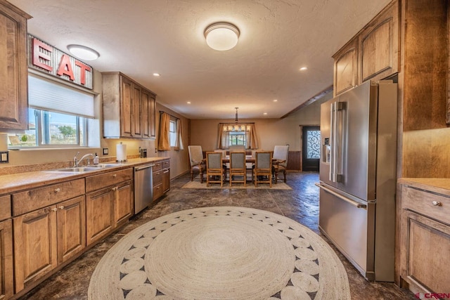 kitchen with pendant lighting, sink, and stainless steel appliances