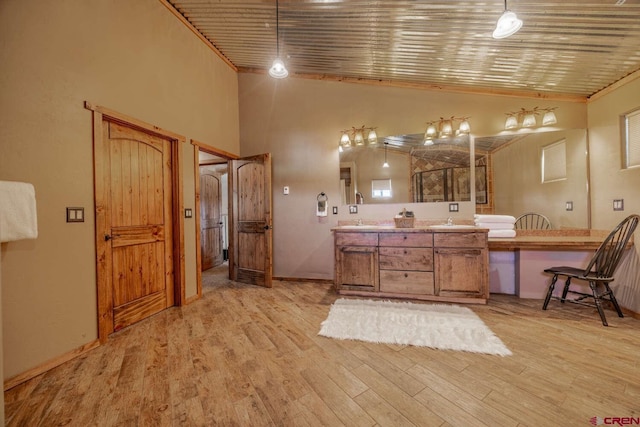 bathroom with wood ceiling, wood-type flooring, high vaulted ceiling, and vanity