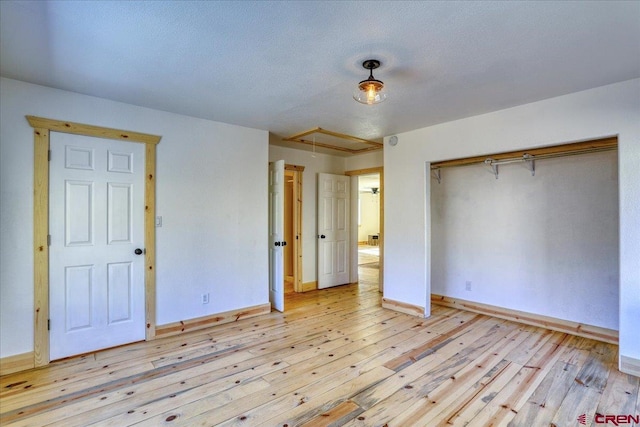 unfurnished bedroom featuring a closet and light hardwood / wood-style flooring