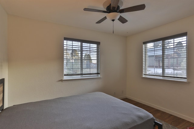 unfurnished bedroom with dark hardwood / wood-style flooring and ceiling fan