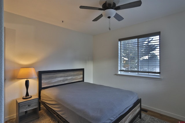 bedroom featuring ceiling fan and dark hardwood / wood-style flooring