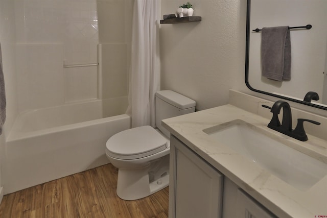 full bathroom featuring wood-type flooring, shower / bath combo, vanity, and toilet