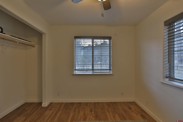 unfurnished bedroom featuring dark hardwood / wood-style flooring, a closet, and ceiling fan