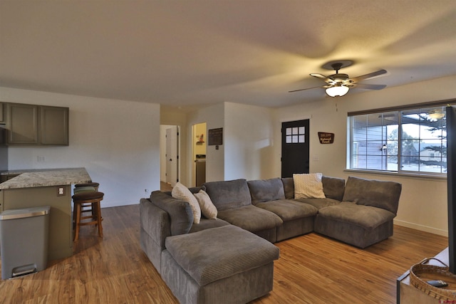 living room featuring dark hardwood / wood-style floors and ceiling fan