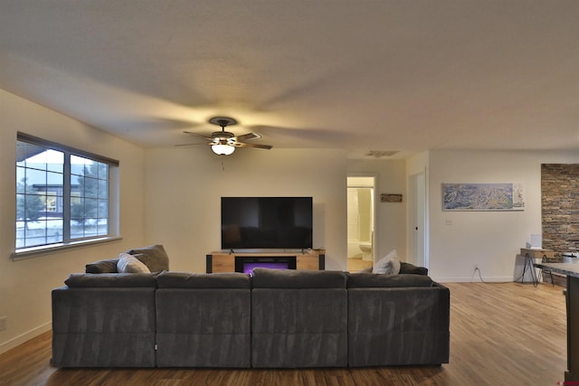 living room with hardwood / wood-style flooring and ceiling fan