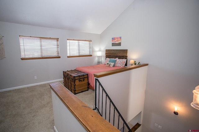 bedroom featuring light colored carpet and vaulted ceiling