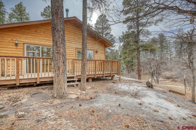 rear view of property with a wooden deck