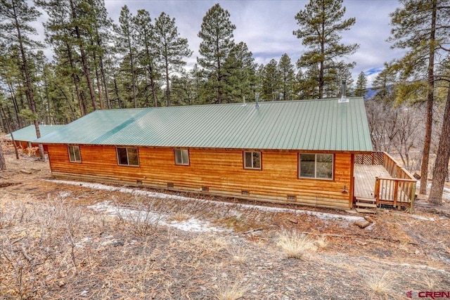 view of side of home featuring a wooden deck