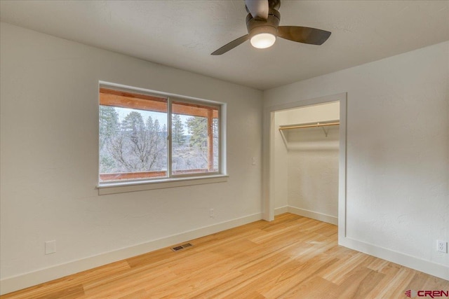 unfurnished bedroom with light hardwood / wood-style flooring, a closet, and ceiling fan