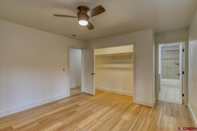 unfurnished bedroom featuring light hardwood / wood-style flooring, a closet, and ceiling fan