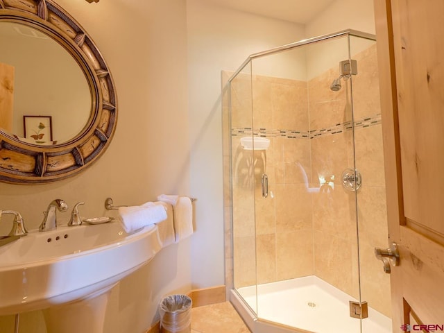 bathroom with an enclosed shower and sink