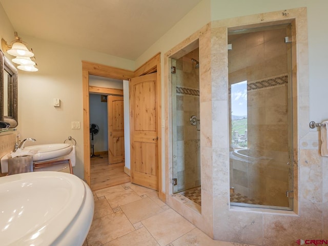 bathroom with an enclosed shower and sink