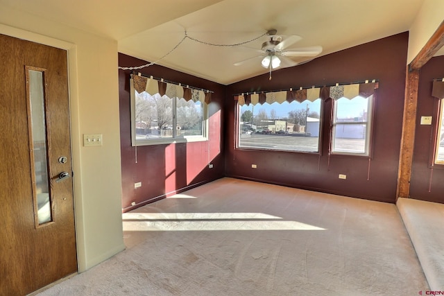 spare room with vaulted ceiling, ceiling fan, plenty of natural light, and carpet floors