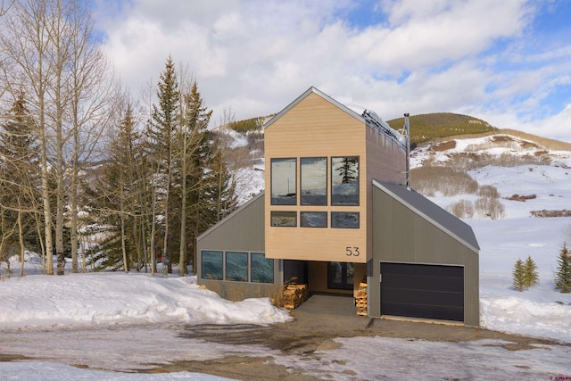 contemporary house with a garage and a mountain view