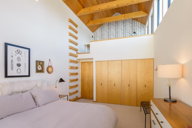 carpeted bedroom featuring wood ceiling, beam ceiling, and high vaulted ceiling