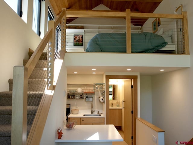 stairs featuring sink and a towering ceiling