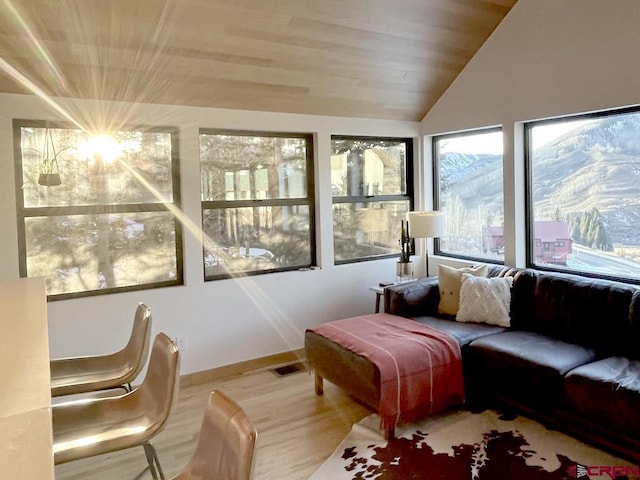 sunroom with vaulted ceiling and wooden ceiling