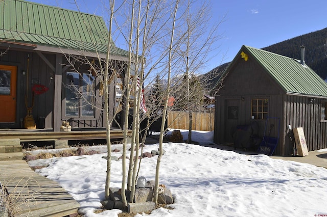 yard layered in snow with an outdoor structure