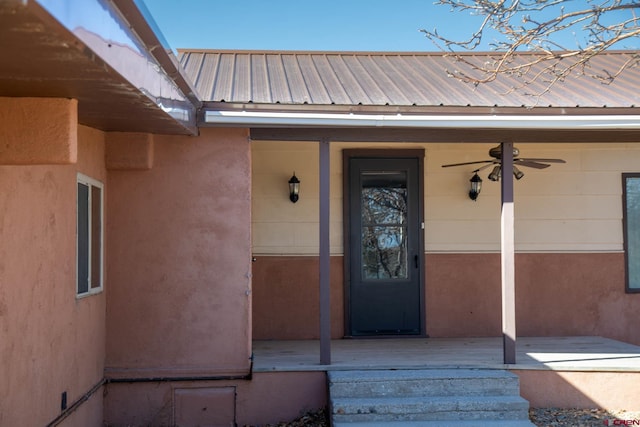 view of exterior entry featuring ceiling fan