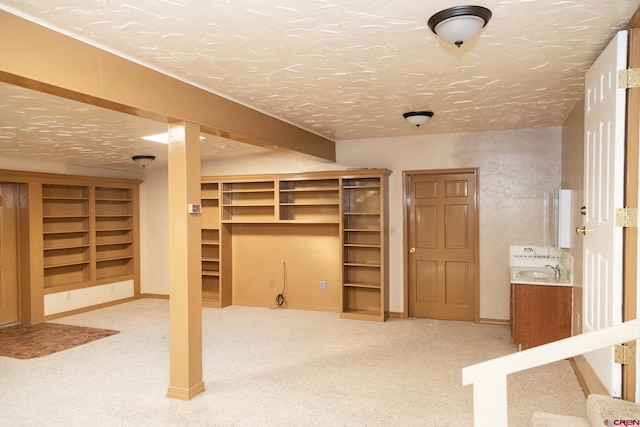 basement featuring a textured ceiling and carpet flooring