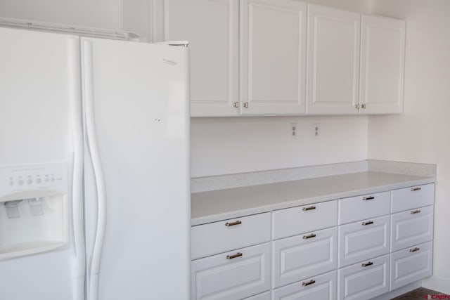 room details featuring white fridge with ice dispenser